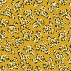 Retro floral pattern in small decorative flowers. Small white flowers. Gold yellow background. Ditsy print. Floral seamless background ditsy pattern in small cute wild flowers.