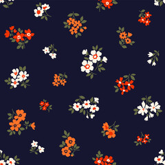 Beautiful floral pattern in small flowers. Small red, orange and white flowers. Dark blue background. Ditsy print. Floral seamless background. Elegant template for fashion prints. Stock pattern.