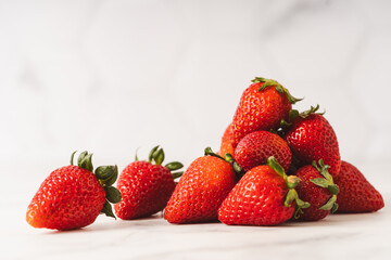 Strawberries stacked on marble counter