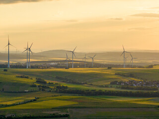 Wind Turbines in a Beautiful Landscape and Sunset Sky. Alternative electricity, sustainable resources, Renewable energy