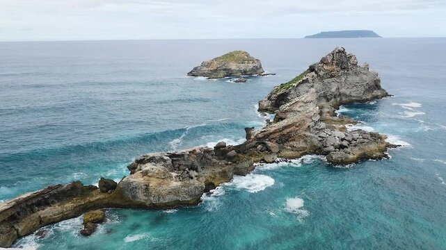 View of calm bumping rocks in the ocean in Pointe des Chateaux in Guadeloupe slow motion	