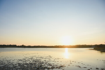 Obraz premium Sunset water surface and shadows of trees