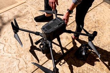person carefully setup a large drone with eight propellers