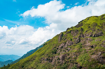 The hillside under blue sky and white clouds
