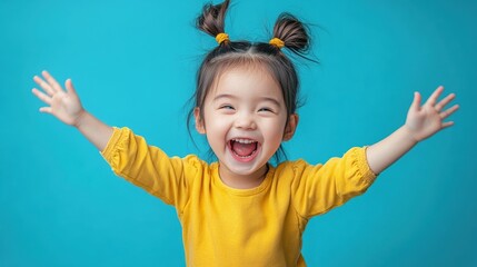 Happy Asian Child Playing and Laughing Against Light Blue Background