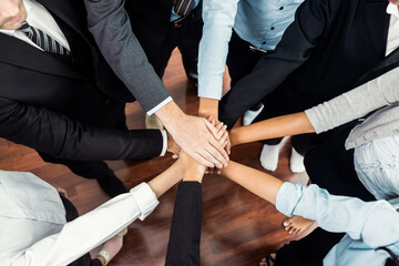 Multiracial business people make synergy hand stack together in meeting room as cooperation or team...