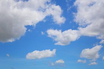 Blue sky with white clouds in the daytime background.