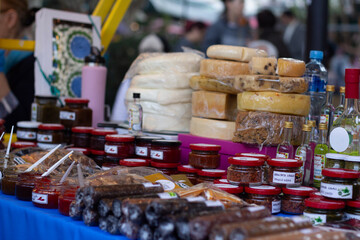 Cheese counter in street store. Table with spices in jars, alcohol, drink, glass bottle. Autumn harvest festival Tbilisoba. Holiday fair. Tbilisi. Georgia. Translation from Georgian: megruli adjika