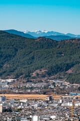 Lijiang City, Yunnan Province, China and the distant mountains.