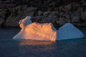 iceberg reflects sunset
