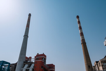 Looking up at the two chimneys of the factory