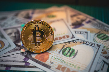 Golden Bitcoin placed on US dollar bills, symbolizing the fusion of cryptocurrency with traditional finance, ideal for themes of digital currency, blockchain, and investment.