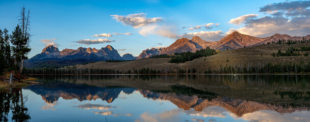 Little Redfish Lake reflection with white swan