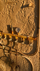 The brake leads to the kitchen with an eye. The rusty gas pipe on the wall of the house is slanted. The sun's rays