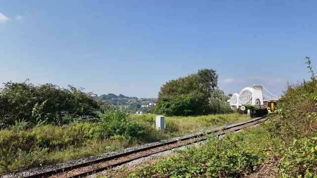 Plymouth Devon England. 30.09.2024. Video. Railway train approaching from the Royal Albert bridge over the River Tamar between Cornwall and Devon UK.