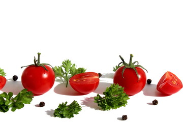 Red ripe cherry tomatoes lie on a white background with parsley.