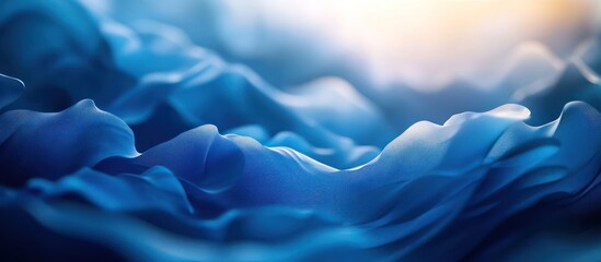 Obraz premium Abstract blue fabric background with soft folds and waves.