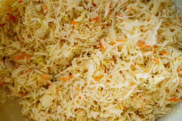Vegetable salad. Shredded cabbage and carrots closeup background. Homemade sauerkraut - fermented cabbage and carrots. healthy food of background