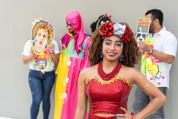 Young woman in carnival costume celebrating with masked performers