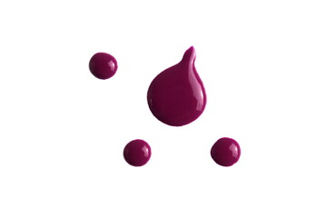 Drops of burgundy nail polish lie on a white background.	