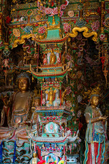 Fototapeta premium Stone statue of cross-legged Bodhisattva in Cave 18 of Yungang Grottoes, Datong, Shanxi Province