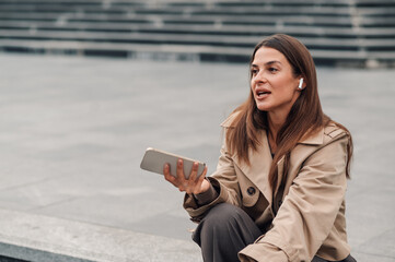 Businesswoman recording voice message using smartphone app