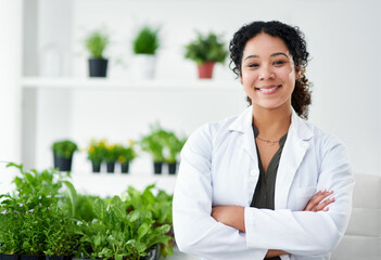 Science, confidence and portrait of happy woman with plants for gmo development, growth or research...