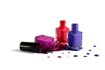 Open spill varnish of three colors in glass bottles is located on a white background.	