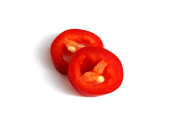Two slices of red hot pepper lie on a white background.