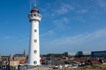 Lighthouse in the Dutch town of Egmond aan Zee with a view of the town