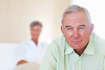 Couch, senior man and thinking after conflict for fight, misunderstanding and upset in lounge. Angry couple, male person and woman on sofa for cheating, affair and husband with divorce ideas at home