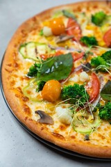 Delicious vegetarian pizza lying on table in restaurant