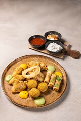 Appetizing deep fried platter served with variety of dipping sauces