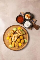 Delicious fried appetizers platter with dipping sauces on table