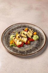Grilled halloumi cheese salad with roasted red pepper and pesto dressing