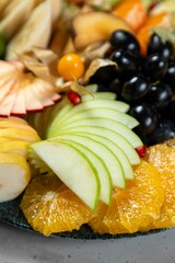 Sliced green apple sits on charcuterie board with fresh fruit