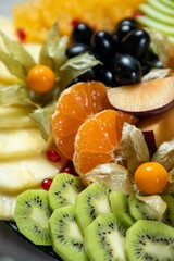 Sliced fresh fruits creating delicious and healthy dessert platter