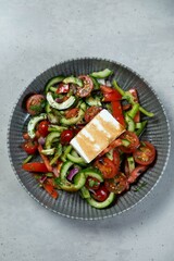 Fresh greek salad with feta cheese in a bowl