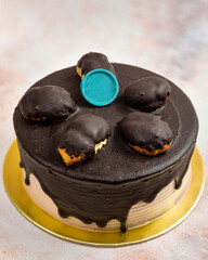 Delicious chocolate cake with chocolate decoration on golden plate