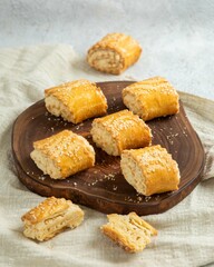 Gata, armenian sweet bread with nuts filling, lying on wooden board, close up