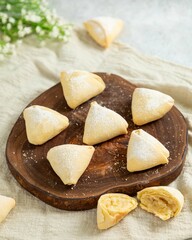 Tasty homemade cookies with cottage cheese filling lying on wooden board