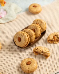 Delicious homemade almond cookies resting on beige tablecloth