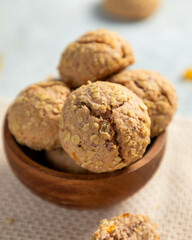 Oatmeal raisin cookies stacked in wooden bowl