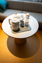 Asian Chinese ceramic tea set in hotel room, warm lighting atmosphere