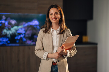 Portrait of confident businesswoman at corporate office smiling at camera