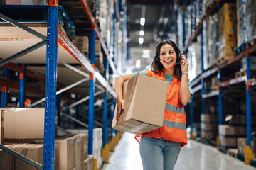 Warehouse worker using headset carrying box