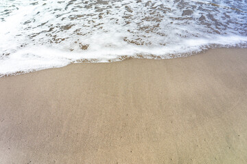 Soft Wave of Blue Ocean on Sandy Beach.