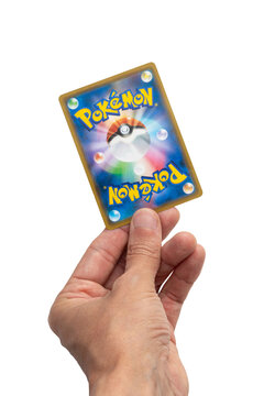 Hand Holding a Pokemon Trading Card on isolated White Background