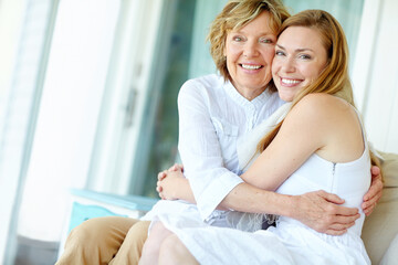 Portrait, mature mother and daughter embrace on sofa with confidence, smile and bonding in living room together. Relax, senior mom and girl with happy hug for love, care and support in family home