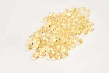 Yellow soft gel capsules on white background: omega-3 and vitamin d supplements for health and wellness in modern nutrition